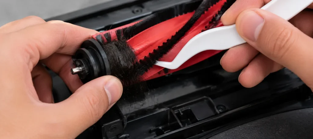 the axle of a red robot vacuum brush roller